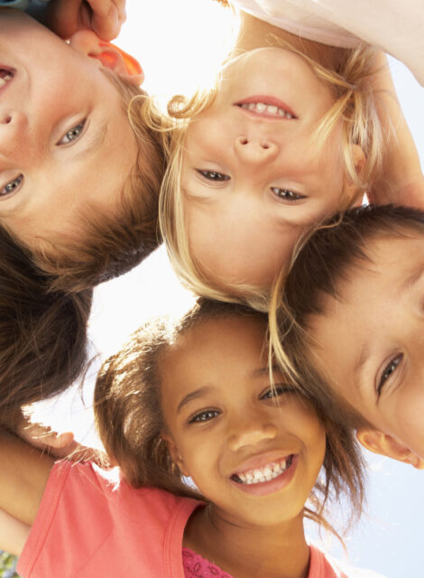Group Of Children Looking Down Into Camera